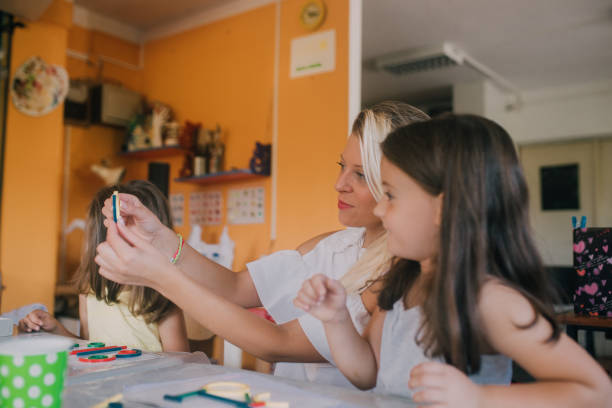 istock Woman playing with her students 1061770330