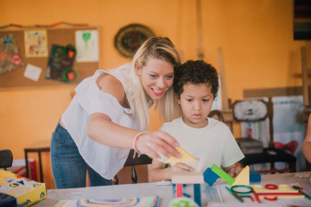 istock Woman playing with young boy at school 1061770496