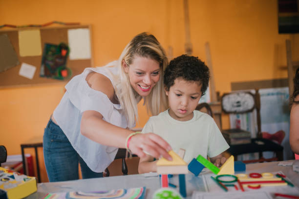 istock Boy playing with art teacher 1061771516