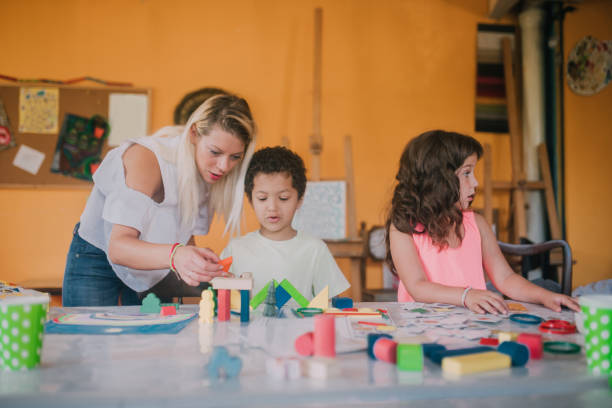istock Woman playing with children 1061771546