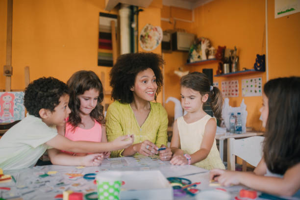 istock Happy teacher with cheerful children 1061771672