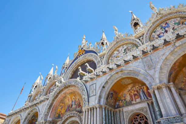 istock Saint Mark basilica facade low angle view with mosaics in Venice, blue sky in Italy 1061771778