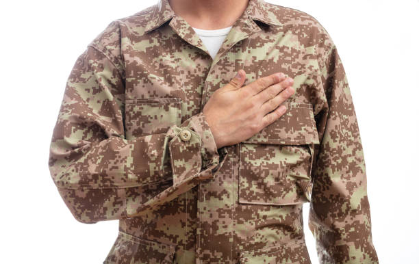 istock Young soldier with hand on heart standing on white background 1061791462
