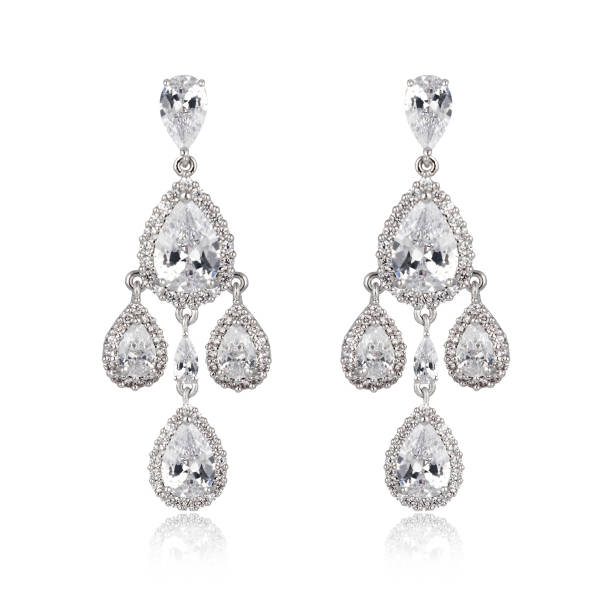 istock Pair of silver diamond earrings isolated on white background 1061797118