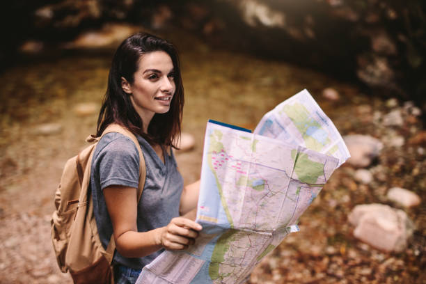 istock Beautiful woman hiker with a map 1061799632