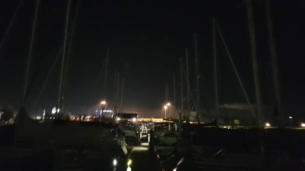 istock view of a jetty with masts across the night sky 1061800816