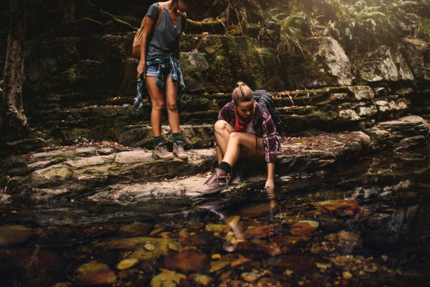 istock Female hikers by a water pond in mountain 1061800828