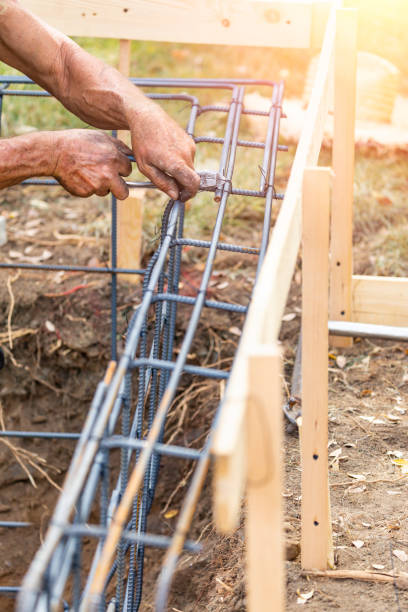 istock Worker Securing Steel Rebar Framing With Wire Plier Cutter Tool At Construction Site 1061803576