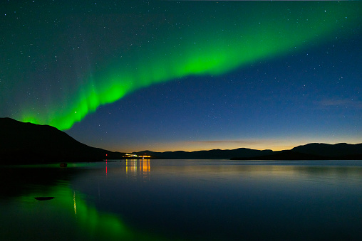 Landscape with Aurora borealis and Tornetrask lake. Northern Sweden