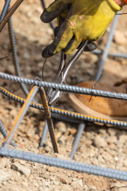 istock Worker Securing Steel Rebar Framing With Wire Plier Cutter Tool At Construction Site 1061803942