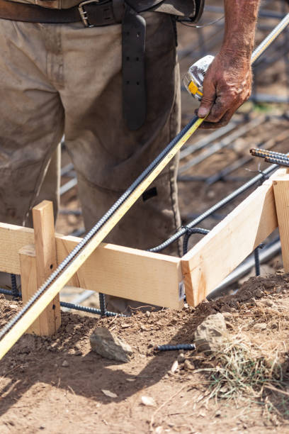 istock Worker Measuring Steel Rebar At Construction Site 1061804358