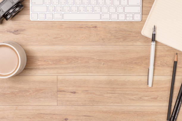 istock Wood office desk table with laptop, glasses, notebook, pen. Top view, copy space. 1061814682