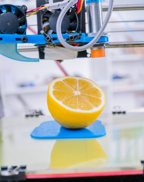 istock Ripe slice of lemon citrus fruit. 3d printer of the device during the processe. 1061815448