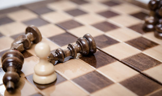 istock One pawn staying against full set of chess pieces.. 1061815628