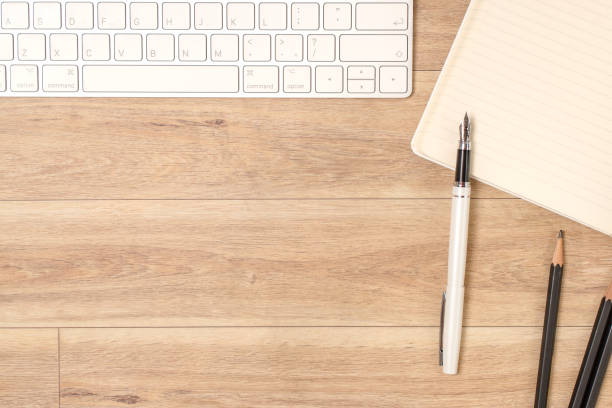 istock Wood office desk table with laptop, glasses, notebook, pen. Top view, copy space. 1061815710