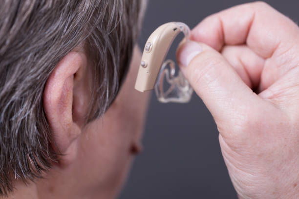 istock Closeup senior woman using hearing aid 1061816122