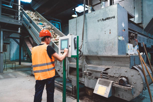 Working with conveyer belt electronics A worker working with conveyer belt electronics in the factory recycling center stock pictures, royalty-free photos & images