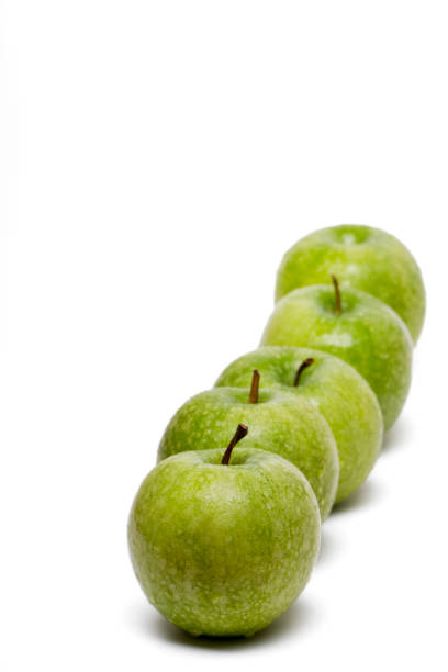 istock row of fresh and healthy green apples 1061824406