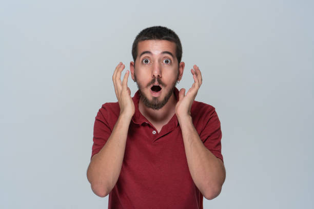 portrait of shocked men over white background portrait of shocked men over white background confusion raised eyebrows human face men stock pictures, royalty-free photos & images