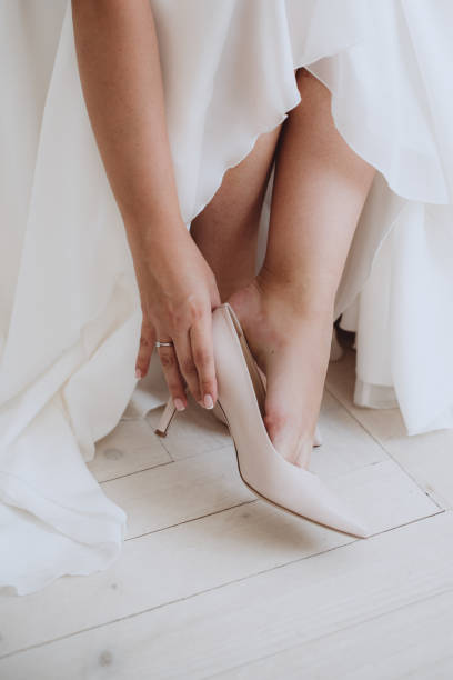 istock Bride putting on wedding shoes 1061828010