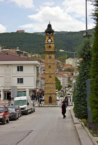 Yozgat, Turkey - April 20, 2018: People on the street with clock tower view in Yozgat. It was built by an ottoman pasha who is called Tevfikizade Ahmet Bey in 1908.
