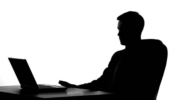 istock Office worker shadow sitting in front of laptop, thinking on business proposal 1061832124