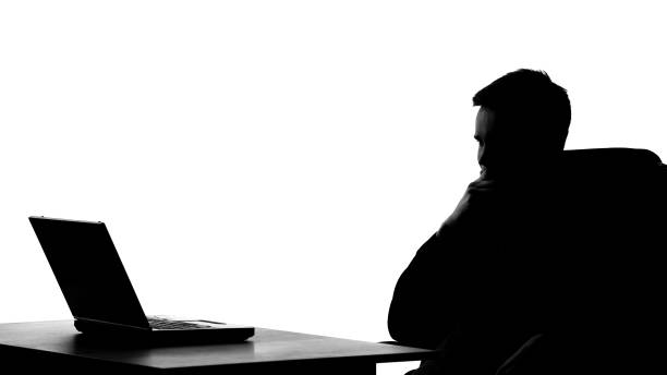 istock Office worker silhouette thinking about business project in front of laptop pc 1061832144