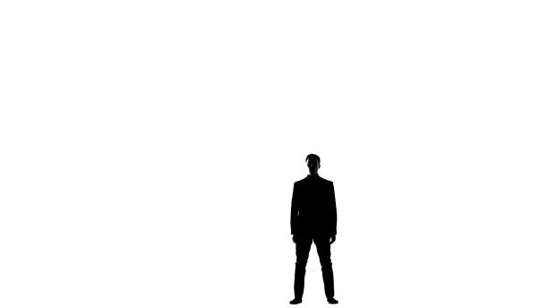 Portrait of a handsome young guy wearing black leather pants, and beige coat isolated on white background