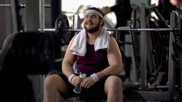 istock Thirsty happy man drinking water after exhausting training, weight loss workout 1061833130