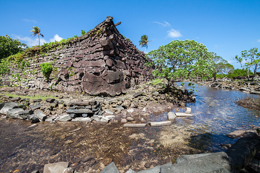 A channel and town walls in Nan Madol - prehistoric ruined stone city built of basalt slabs. Ancient walls were built on coral artificial islands in the lagoon of Pohnpei, Micronesia, Oceania.