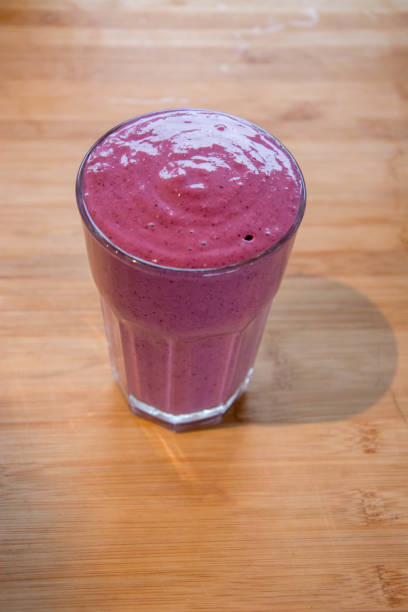 istock pink berry smoothie on plain wooden background 1061835106