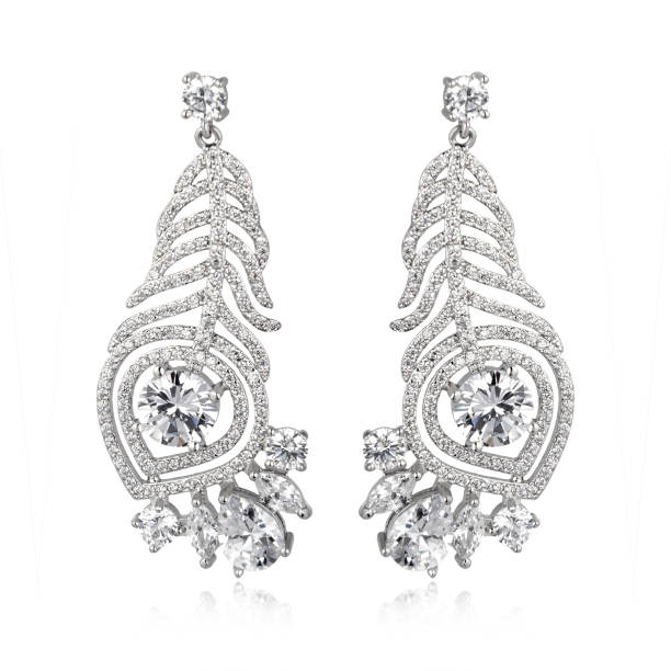 istock Pair of silver diamond earrings isolated on white background 1061837776