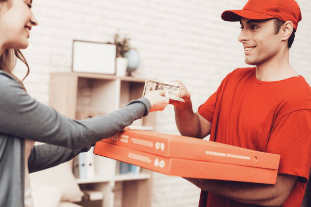 istock Smiling Woman Pizza Delivery Payment Delivery Man. 1061843632