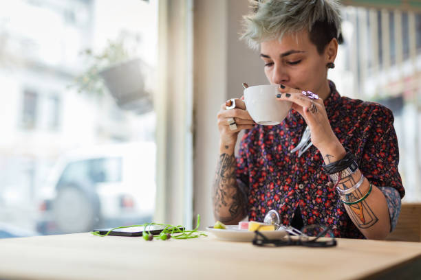 istock Modern genderblend girl drinking tea at a cafe 1061845258