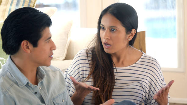 istock Husband and wife sit on floor arguing 1061845430