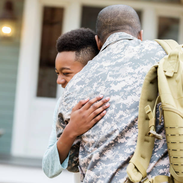 istock Preteen boy happy to see his dad home from deployment 1061847800