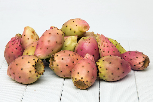 View of a Opuntia ficus-indica cactus fruits on a white wooden background.