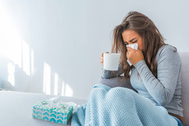 portrait of ill woman caught cold - doença imagens e fotografias de stock