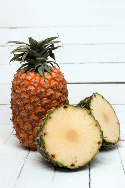 istock Fresh azores pineapple fruit isolated on a white wooden background. 1061851080