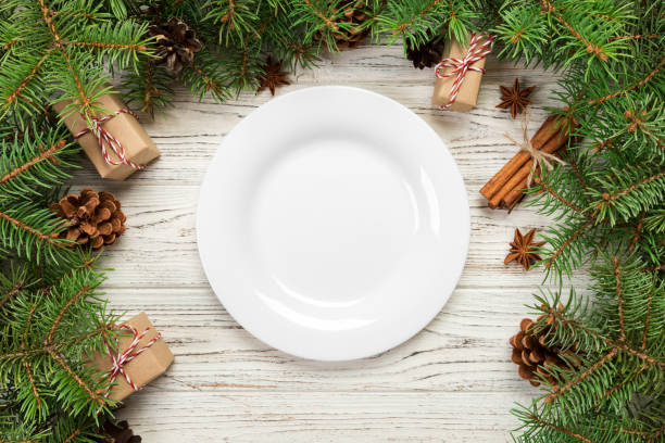 istock top view. Empty plate round ceramic on wooden christmas background. holiday dinner dish concept with new year decor 1061852692