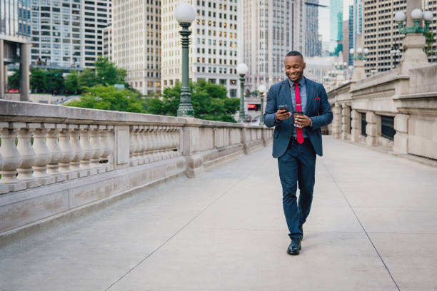 istock Businessman with headset walking in chicago using his mobile phone 1061856042