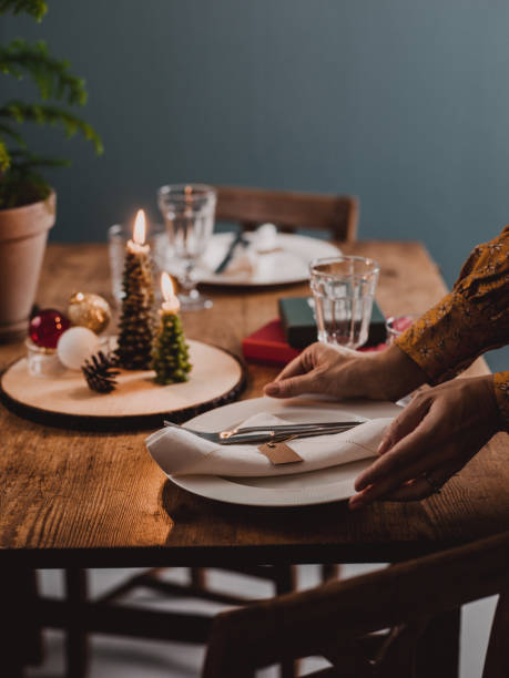 istock Woman setting the Christmas table preparing for dinner party 1061856240
