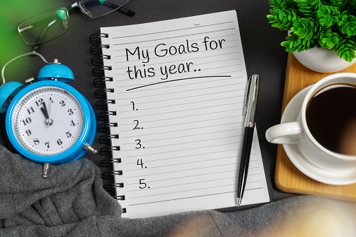 New year's resolution concept. Notepad on black home office desk - My Goals for this Year.