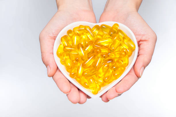 istock Omega 3 capsules in woman hands 1061856674
