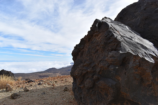 Big black lava stones at the hiking trail to the big famous volcano Pico del Teide in Tenerife, Europe