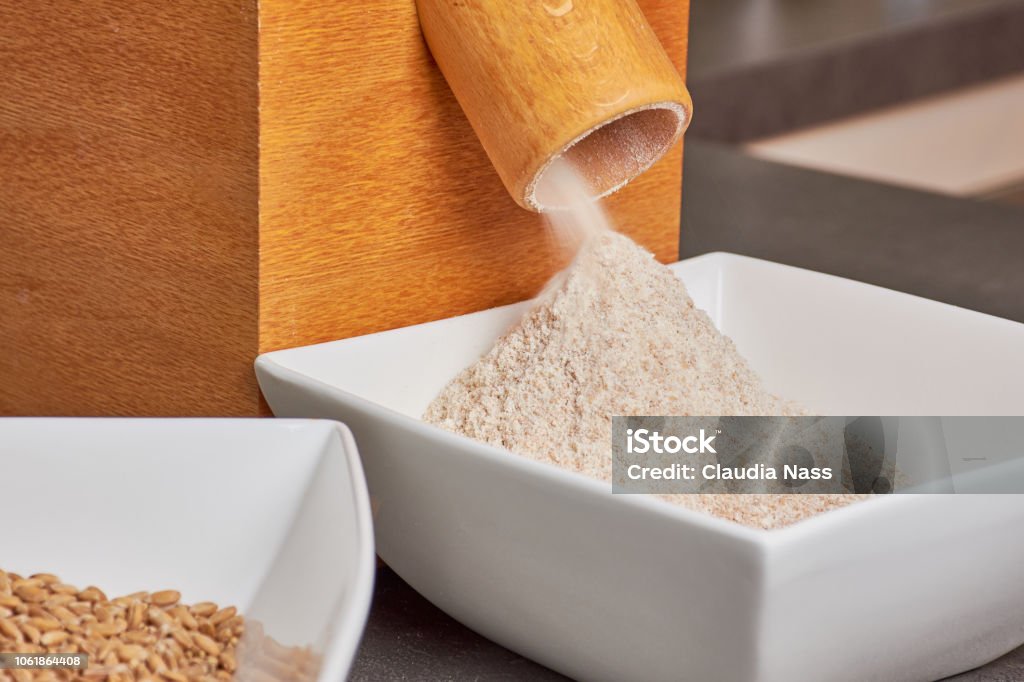 flour mill with fresh spelt flour freshly ground spelt grains in a domestic flour mill Flour Mill Stock Photo