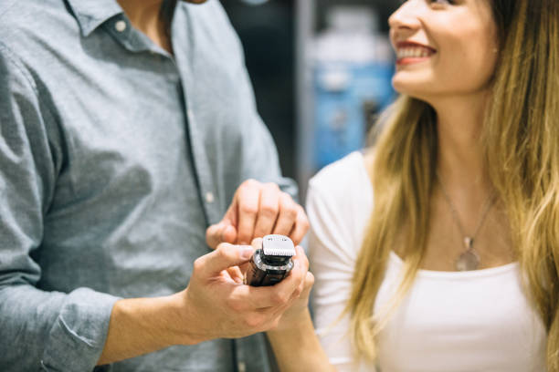 istock Smiling couple choosing a shaver in a store 1061866318