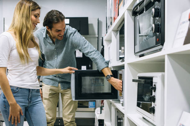 istock Couple choosing a microwave oven in a store 1061866396
