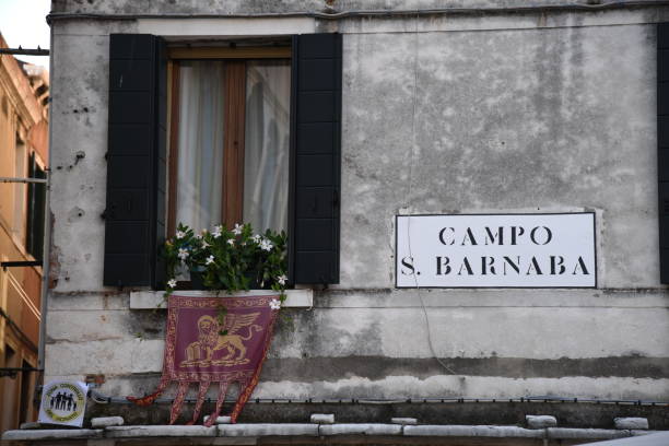 istock Window, flowers and Venetian flag next to sign 1061866862