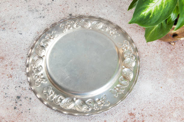 istock Vintage silverplate dish and green plants 1061873464